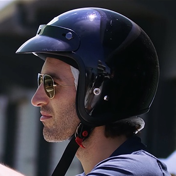 side profile of a man wearing a helmet and sunglasses