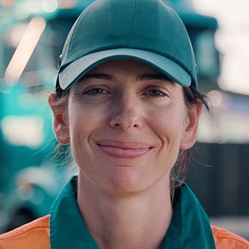 Headshot of a female Toll employee smiling with a baseball hat on