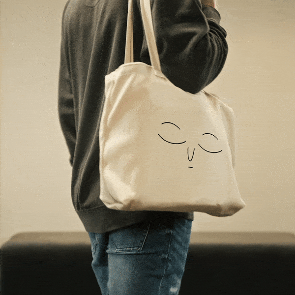 Toby tote bag with struck eyes during the LIV Munro hero video.