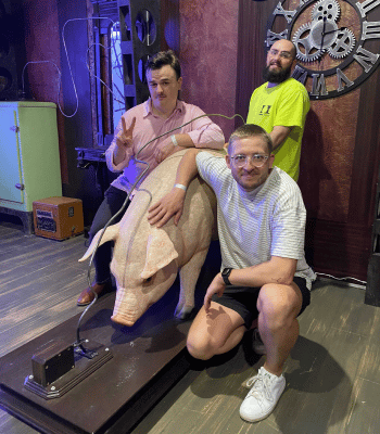 Noah, Charlie and Joel hanging out with a statute of a pig on our team day out.