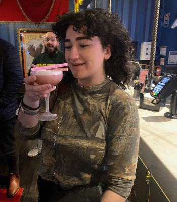Issy on team day out with a budget-breaking fancy pink cocktail.