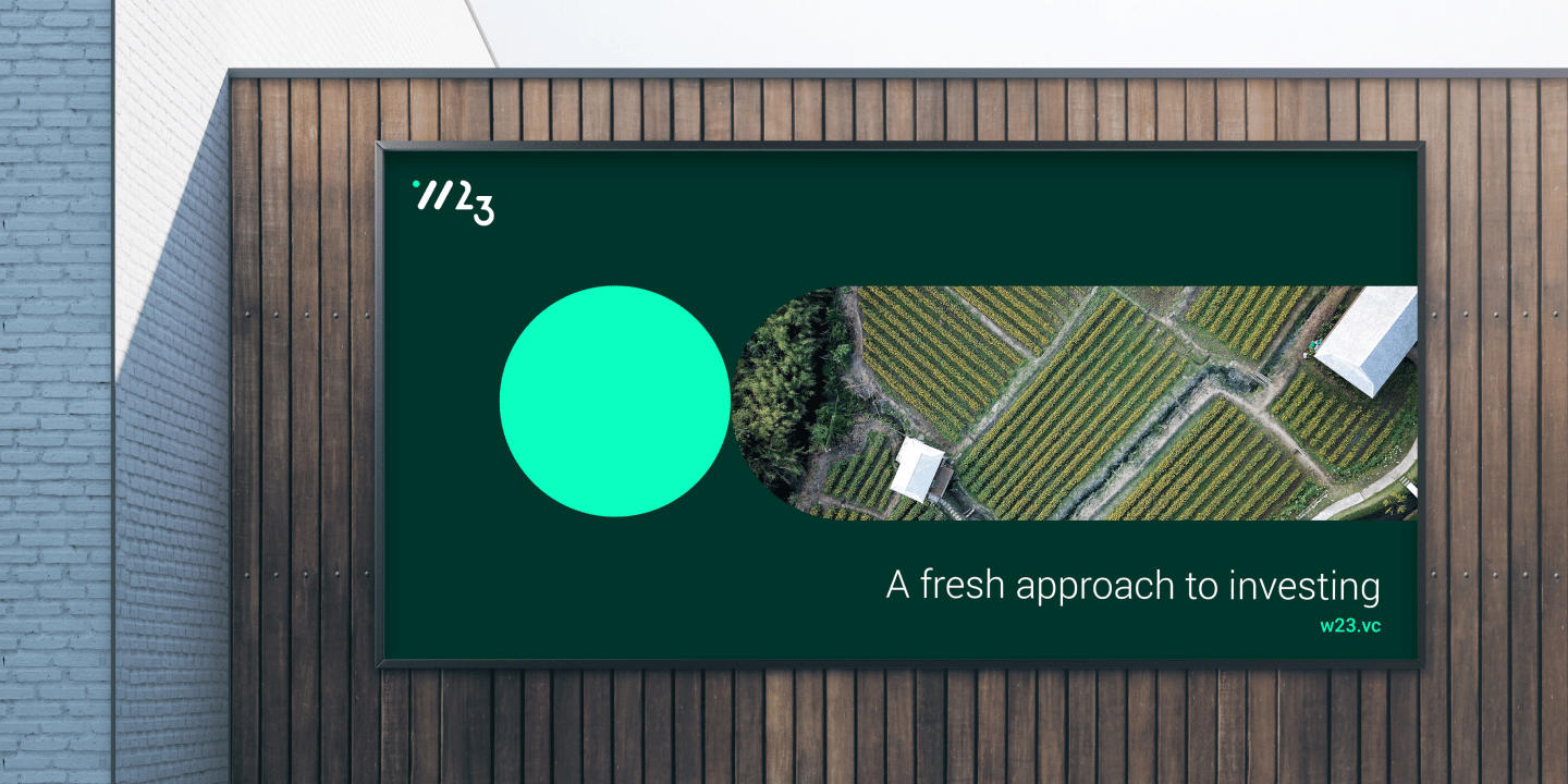 W23 rebrand billboard in an outdoor setting featuring an eagle eye shot of a farm.