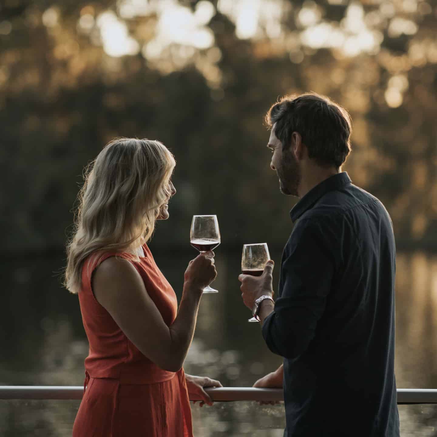 Shot of a couple drinking wine on the balcony at an Ingenia Holiday Park.