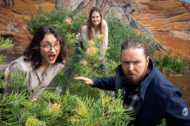 Ceri, Lauren and Shea recreate a scene from Jurassic Park by hiding in a bush
